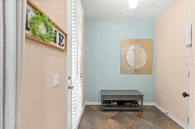 a view of a room that has a bed and a window in it