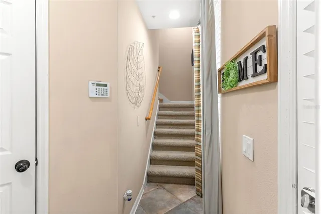 a view of a hallway with wooden floor and entryway
