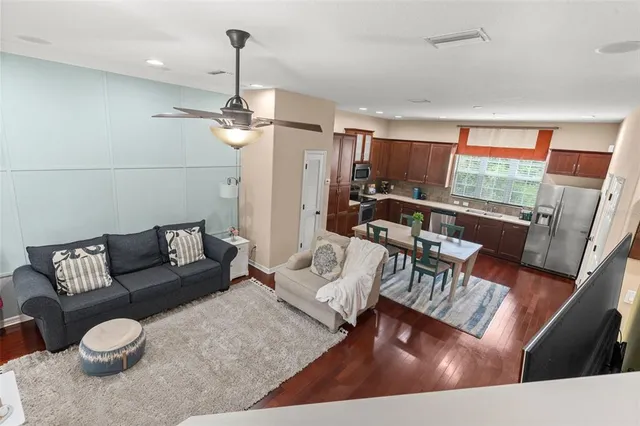 a living room with furniture and a wooden floor