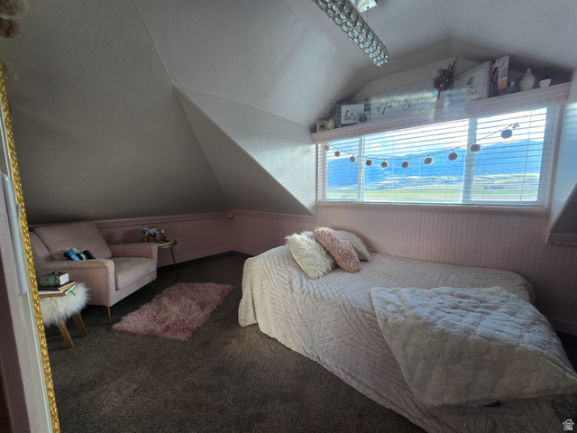 34200 Coulam Road Swan Lake, ID 83281 - Photo 11 of 24 Attic room featuring sloped ceilings, a wide horizontal window with integrated blinds, and beadboard paneling