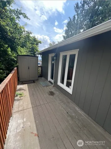 a view of backyard with hardwood floor and gate