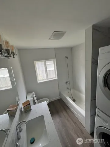a bathroom with a tub sink and mirror