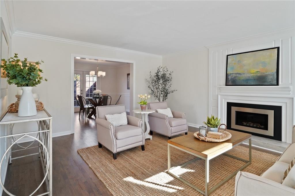 1 Pendleton Place Northeast Atlanta, GA 30342 - Photo 1 of 1 a living room with furniture a fireplace and a flat screen tv