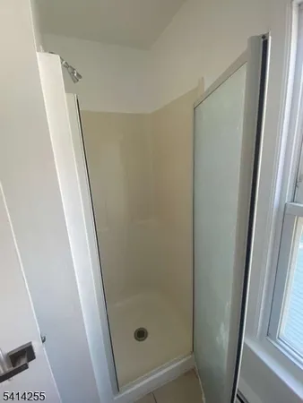 a bathroom with a shower and a mirror