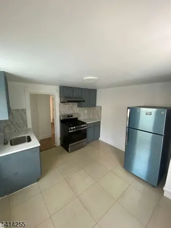 a kitchen with stainless steel appliances a refrigerator and a sink