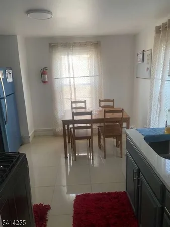 a dining room with furniture and a window