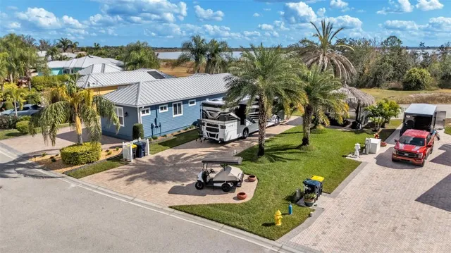 a view of a house with a yard and sitting area