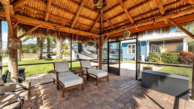 a swimming pool with outdoor seating and yard