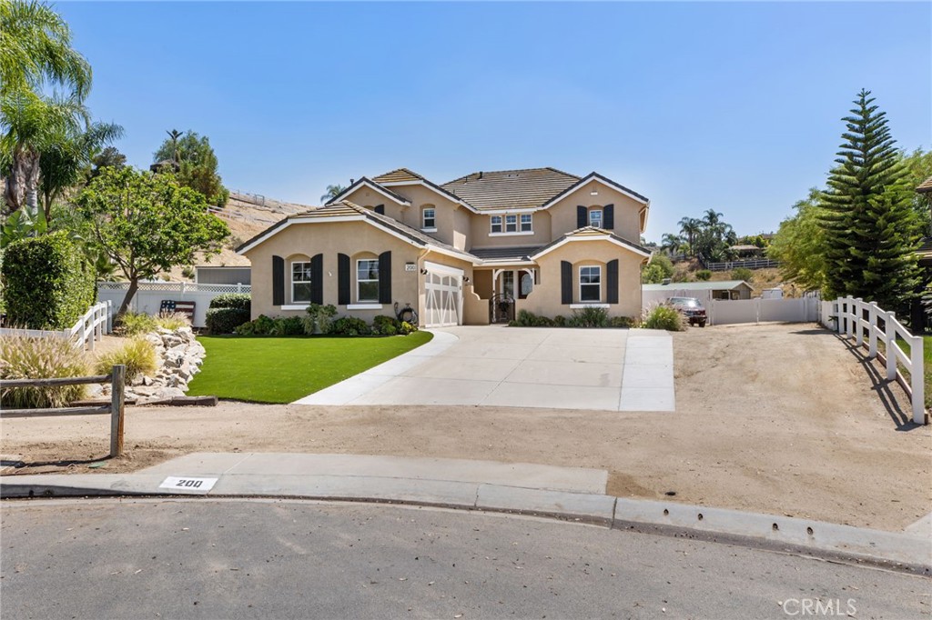 200 Pompano Place Norco, CA 92860 - Photo 2 of 75 a front view of a house with a yard and garage