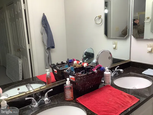 a bathroom with a sink vanity mirror and toilet