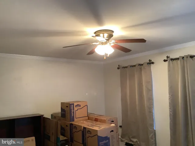 a view of a room with a hanging light and kitchen