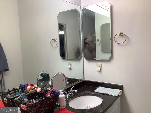 a bathroom with a toilet mirror and sink