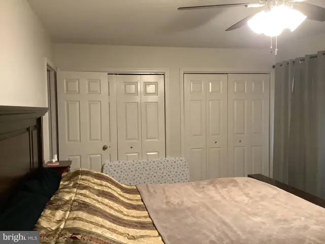 a bedroom with a bed and a mirror