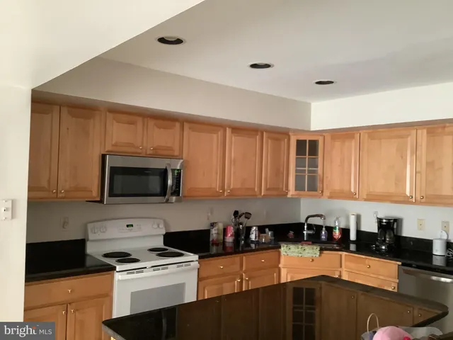 a kitchen with a stove a sink and a microwave