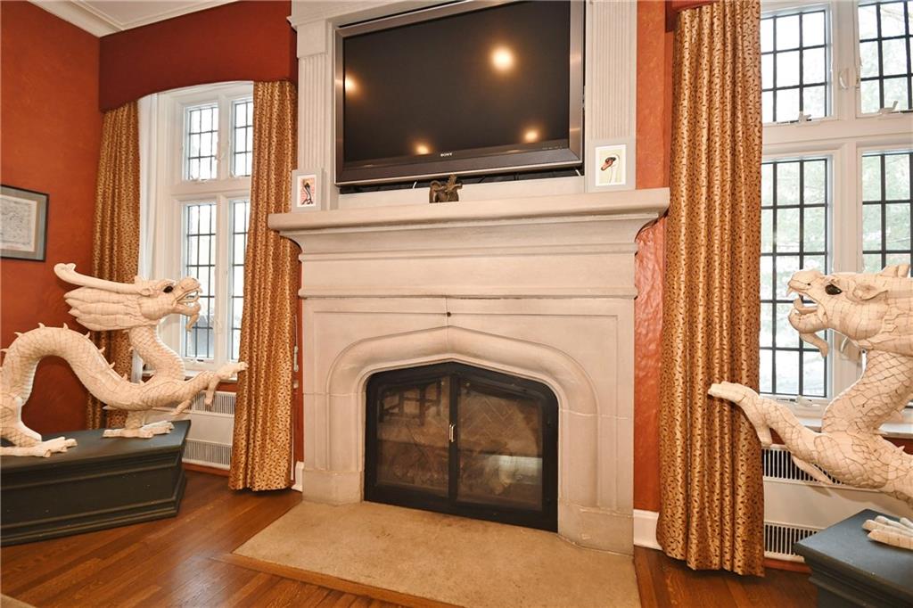 715 Delafield Road Pittsburgh, PA 15215 - Photo 5 of 25 Stone fireplace is flanked by leaded glass floor to ceiling windows.