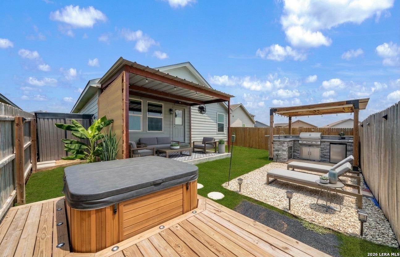 6566 Runaway Row Converse, TX 78109 - Photo 25 of 27 a view of a house with backyard and sitting area