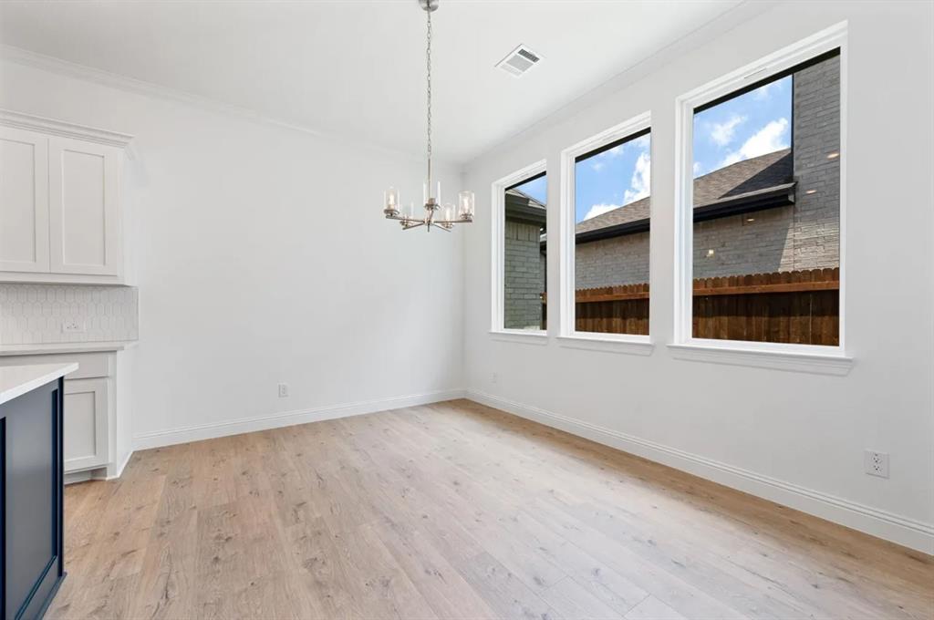 9337 Loggerhead Way Fort Worth, TX 76118 - Photo 21 of 40 a view of an empty room with window and wooden floor