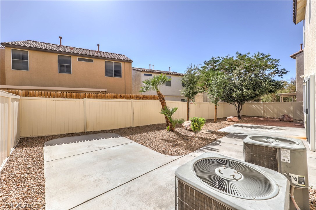 10939 Paradise Road Henderson, NV 89052 - Photo 34 of 36 A private outdoor space with durable concrete paving and low-maintenance landscaping for relaxed living.