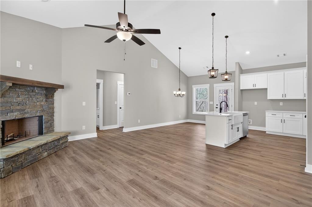 423 Relay Road Silver Creek, GA 30173 - Photo 14 of 48 a view of empty room with kitchen and fireplace