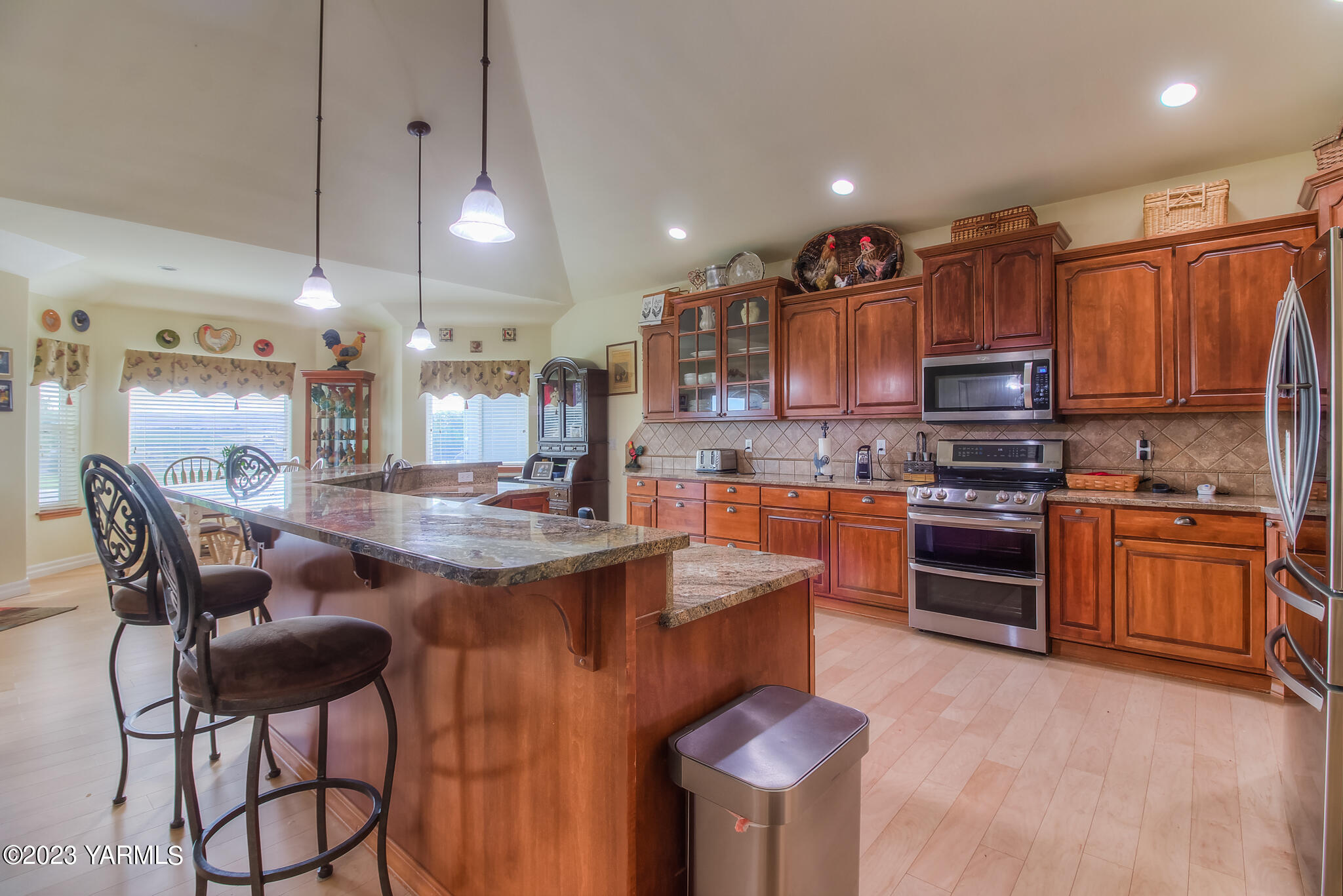 654 South Friedline Road Yakima, WA 98908 - Photo 7 of 34 a kitchen with kitchen island granite countertop wooden cabinets and a stove