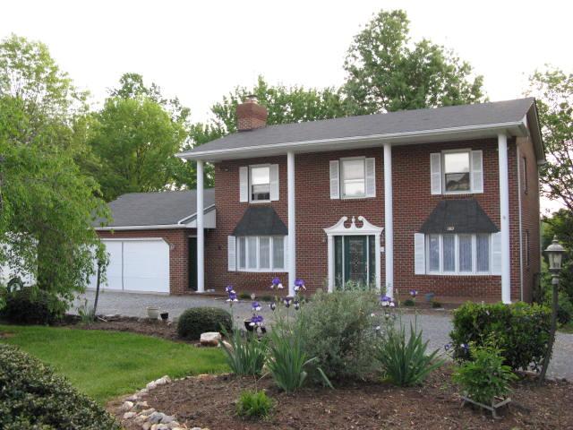 1383 Johnson School Road Thaxton, VA 24174 - Photo 1 of 22 a front view of a house with garden