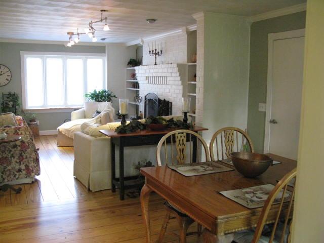 1383 Johnson School Road Thaxton, VA 24174 - Photo 11 of 22 a kitchen with sink a stove and a dining table with wooden floor