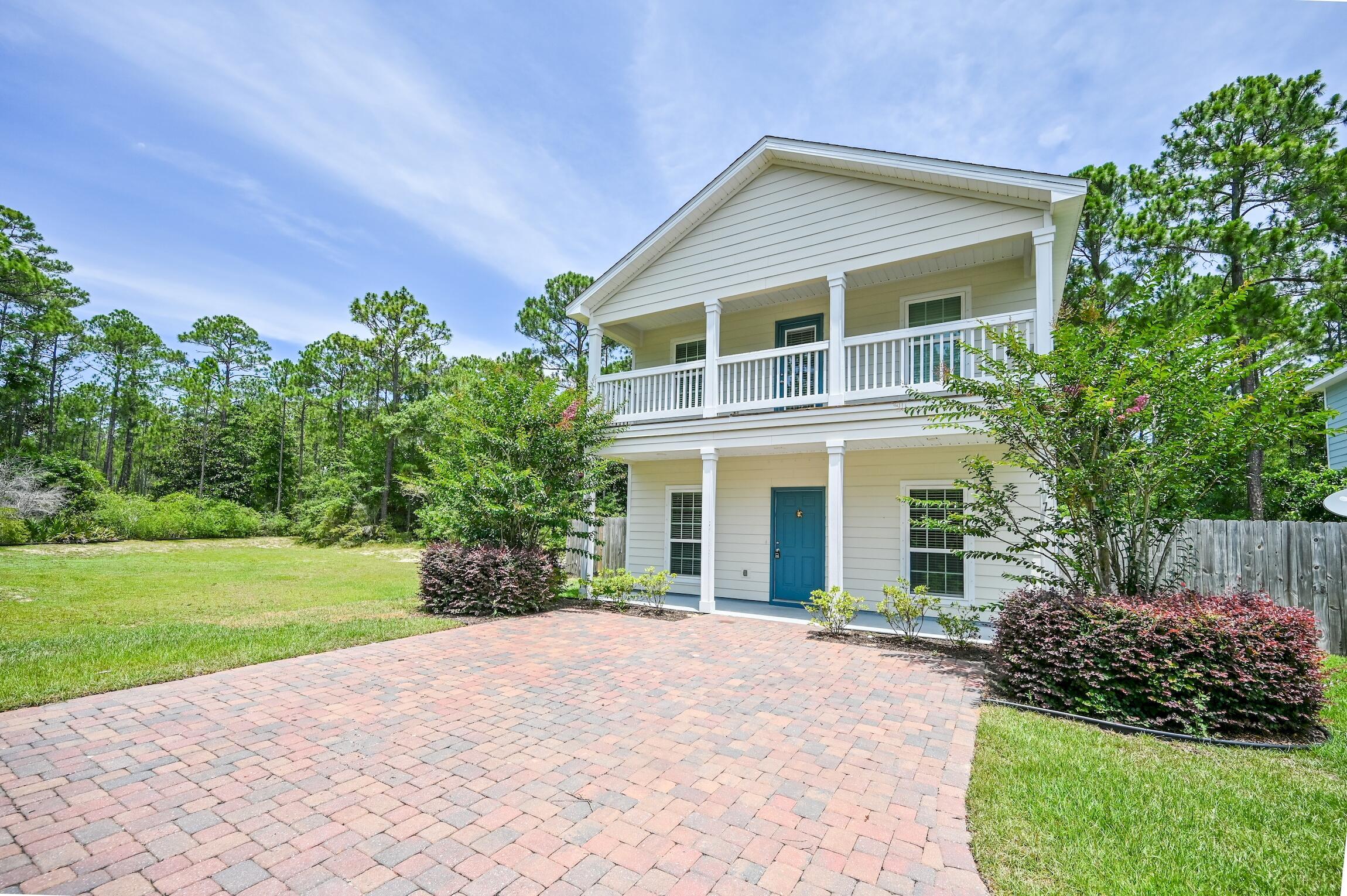 74 Tranquility Lane Santa Rosa Beach, FL 32459 - Photo 1 of 49 a front view of a house with a yard and garage