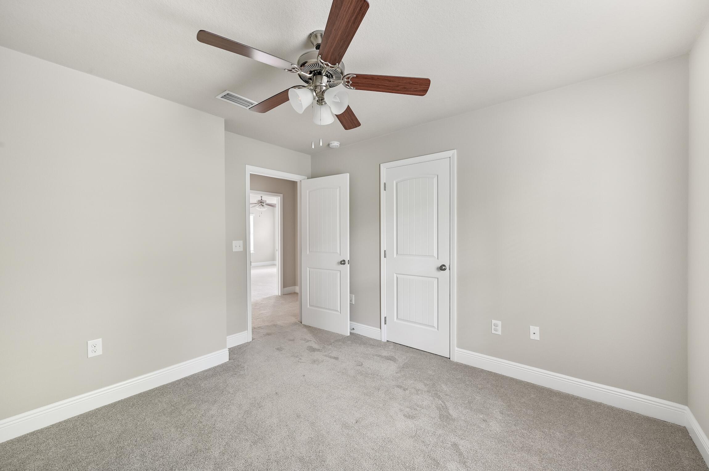 74 Tranquility Lane Santa Rosa Beach, FL 32459 - Photo 20 of 49 a view of an empty room and chandelier fan