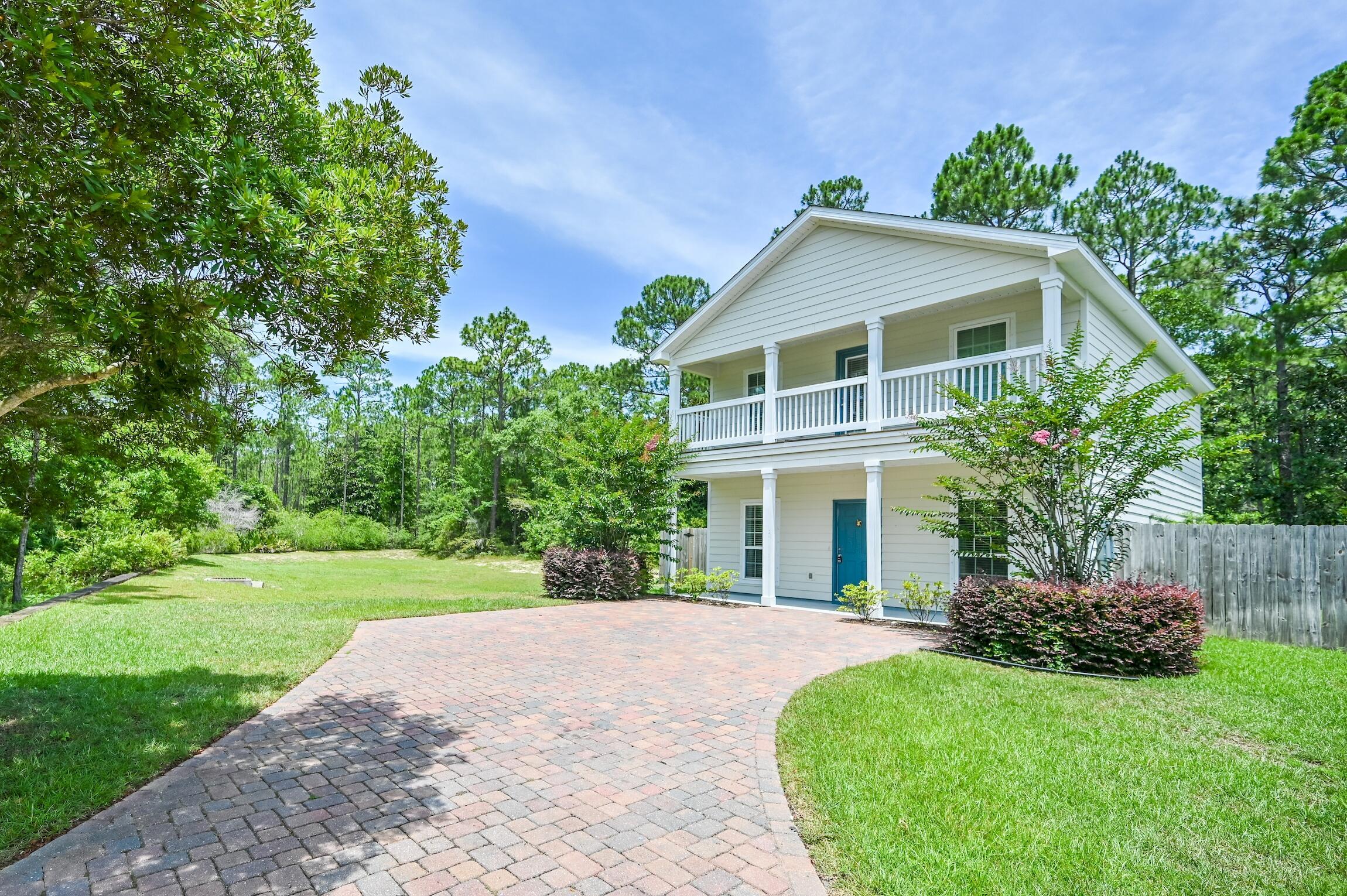 74 Tranquility Lane Santa Rosa Beach, FL 32459 - Photo 2 of 49 a front view of a house with a yard