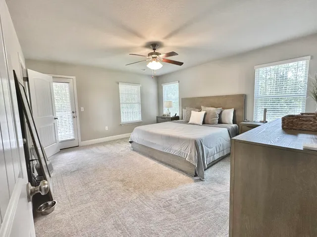 a spacious bedroom with a bed and a chandelier