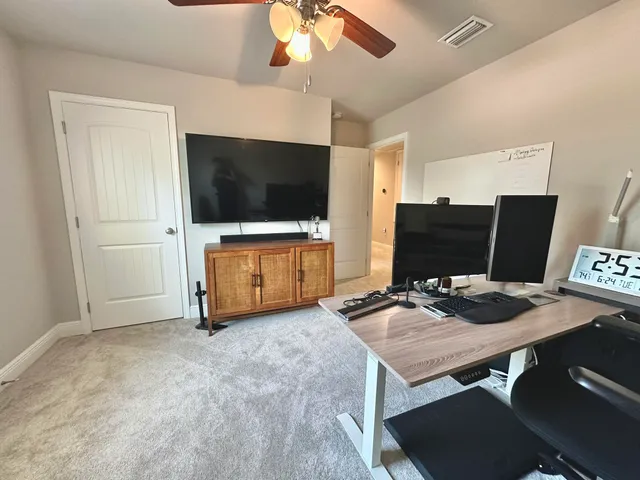 a bedroom with furniture and a flat screen tv