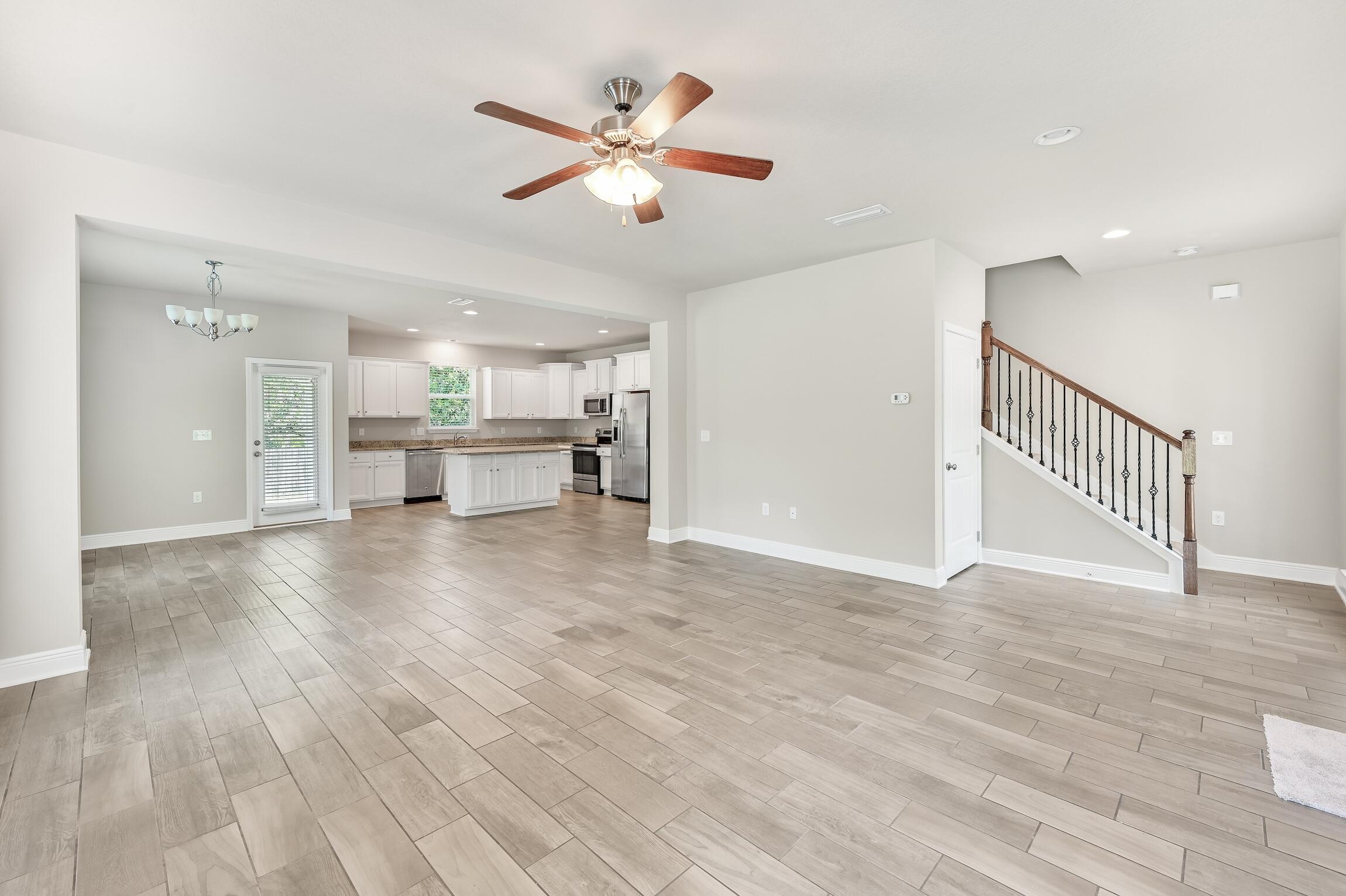 74 Tranquility Lane Santa Rosa Beach, FL 32459 - Photo 4 of 49 a view of a livingroom with a fireplace a ceiling fan and wooden floor