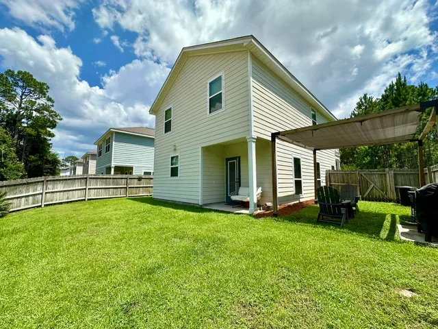 a front view of house with yard and outdoor seating