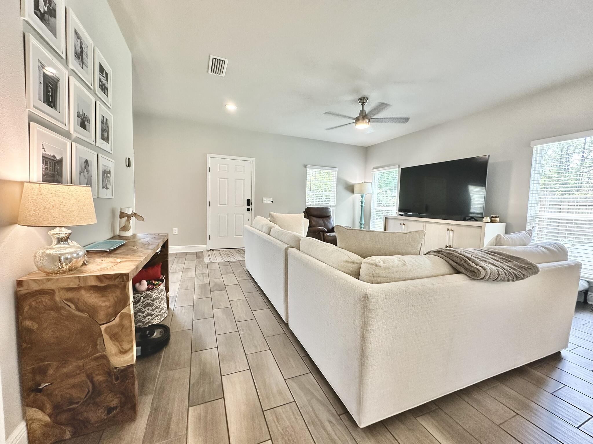 74 Tranquility Lane Santa Rosa Beach, FL 32459 - Photo 8 of 49 a living room with a couch and a flat screen tv
