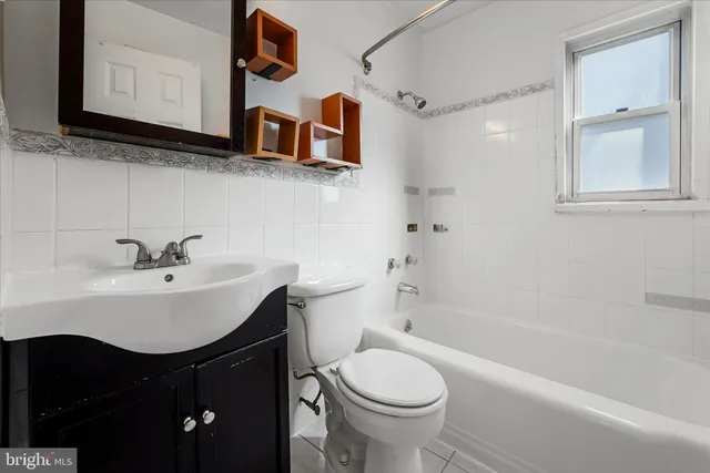 a bathroom with a sink a toilet and bathtub
