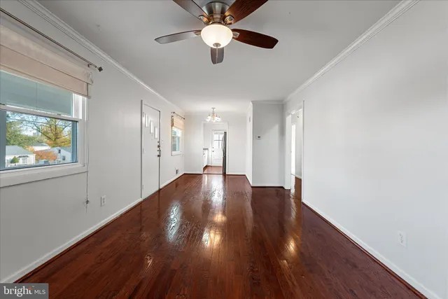 a view of empty room with wooden floor
