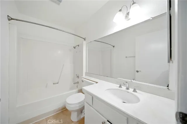 a bathroom with a sink a toilet and a large mirror