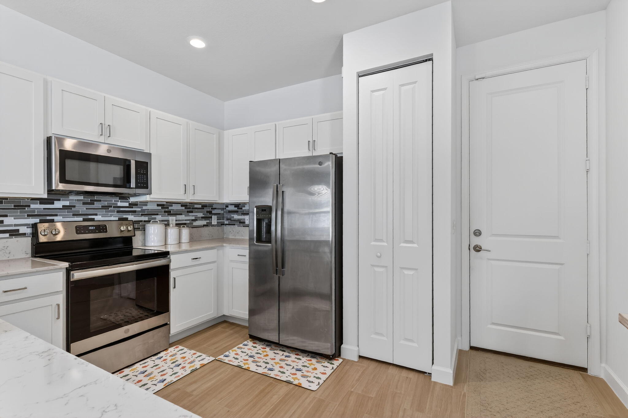 1011 Willow Place Riviera Beach, FL 33410 - Photo 11 of 65 a kitchen with granite countertop a refrigerator stove and microwave