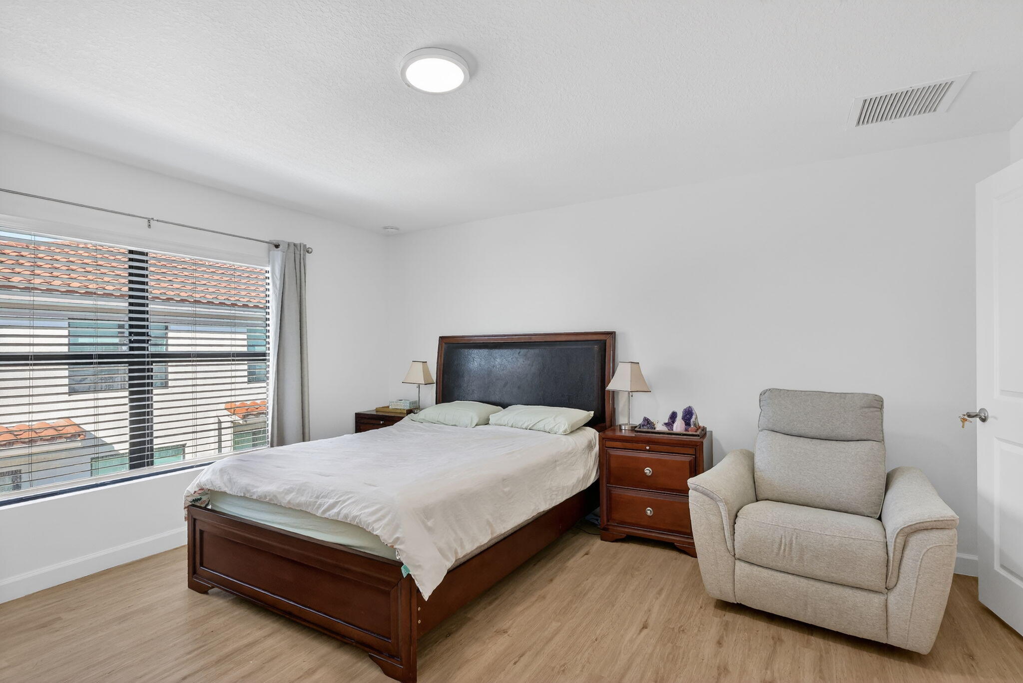 1011 Willow Place Riviera Beach, FL 33410 - Photo 22 of 65 a bedroom with a bed and window