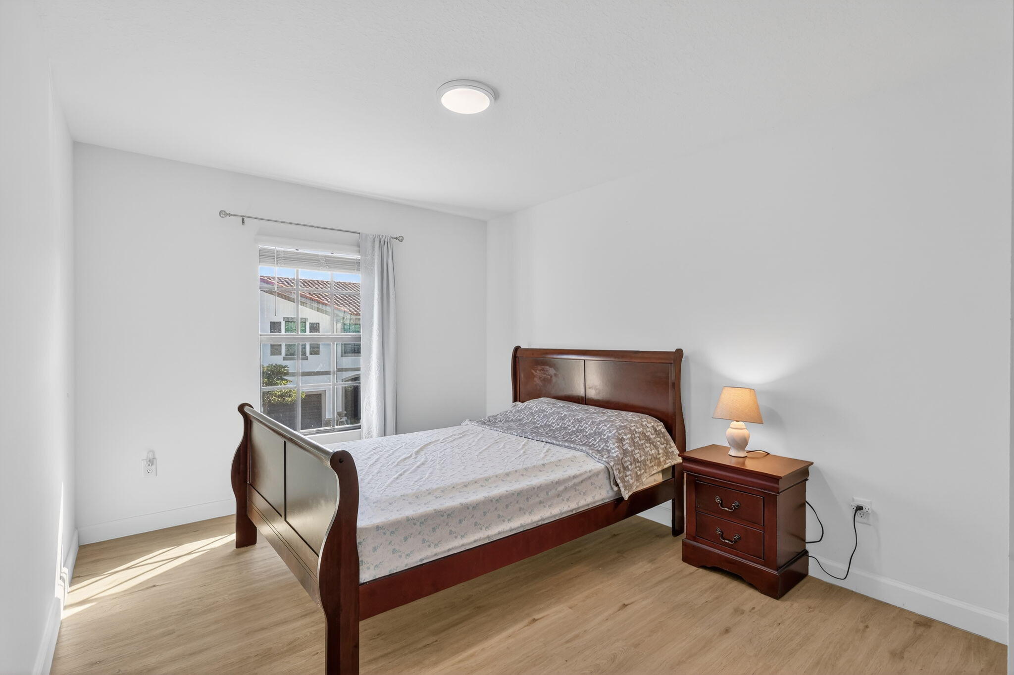 1011 Willow Place Riviera Beach, FL 33410 - Photo 27 of 65 a bedroom with a bed and a table in it