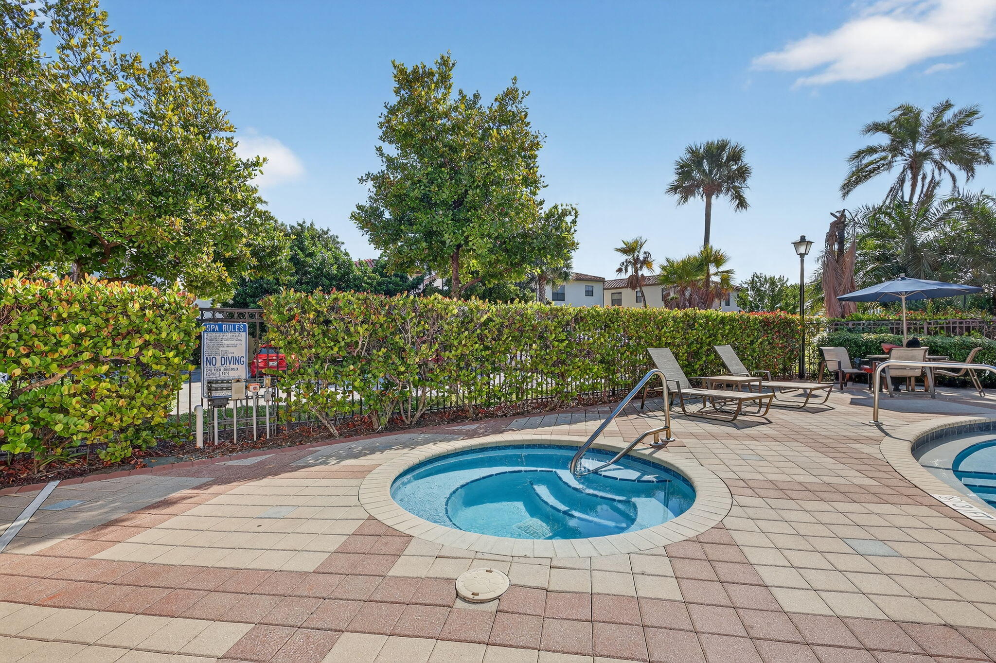 1011 Willow Place Riviera Beach, FL 33410 - Photo 49 of 65 a swimming pool with outdoor seating and plants