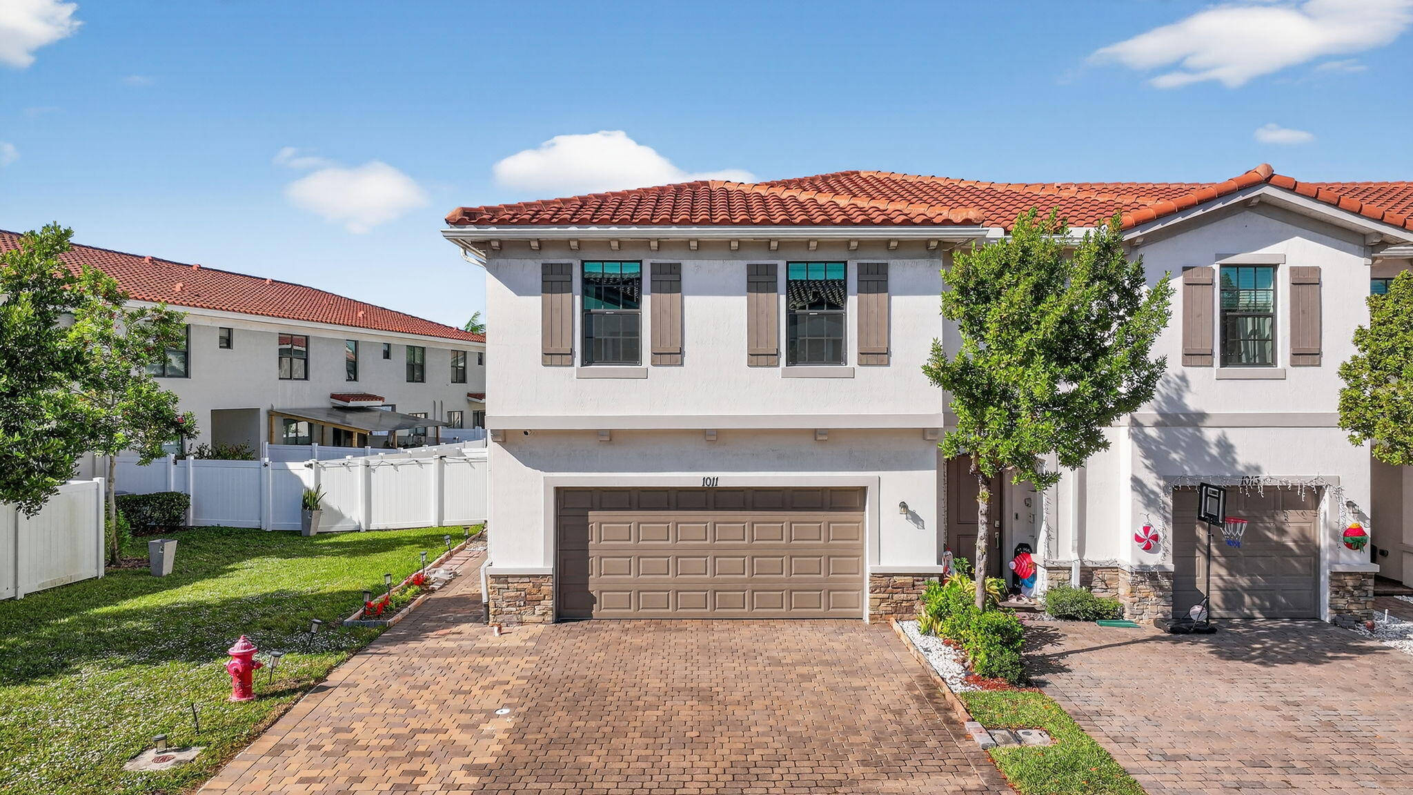 1011 Willow Place Riviera Beach, FL 33410 - Photo 53 of 65 a front view of a house with a garden and plants