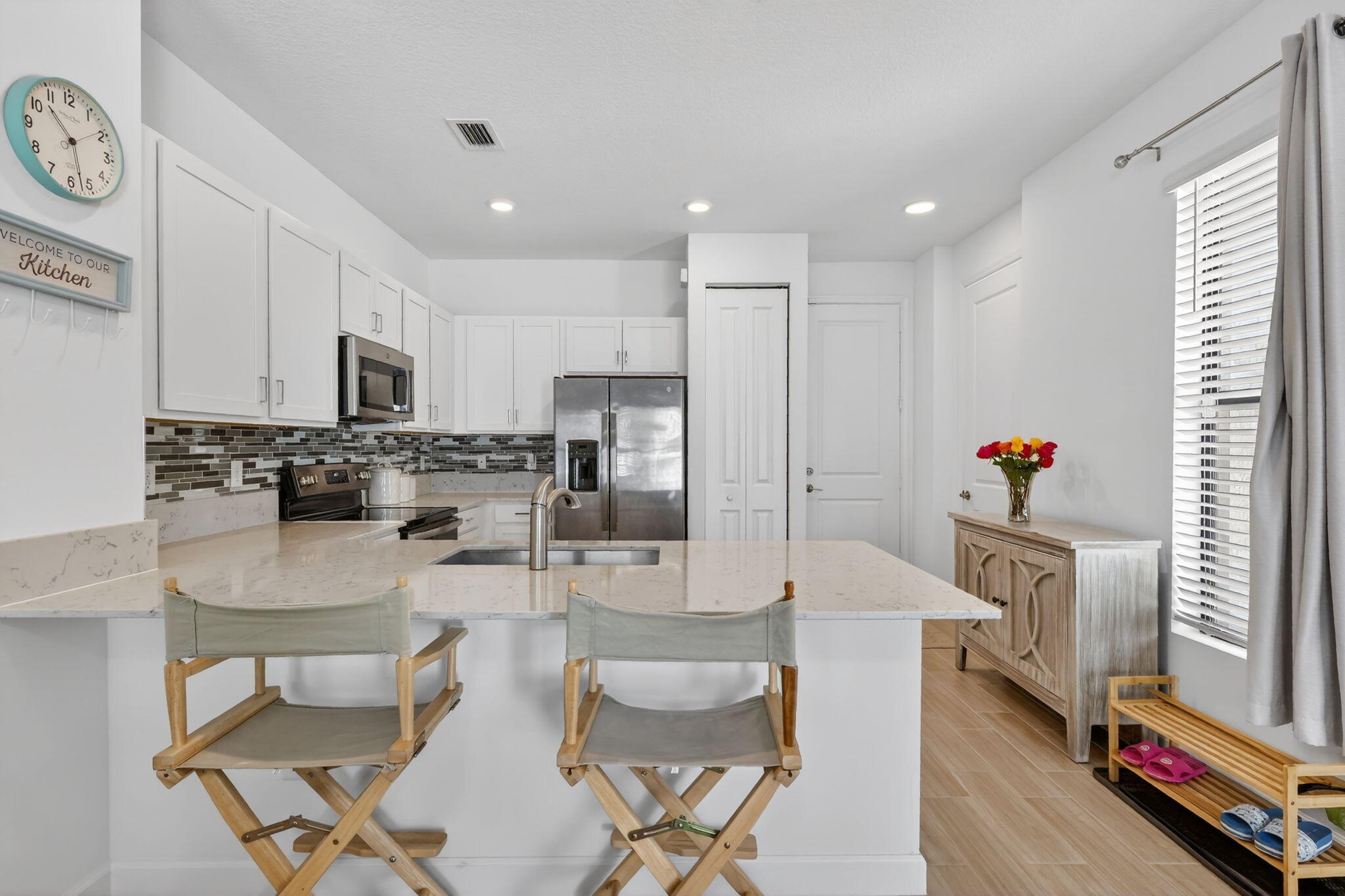 1011 Willow Place Riviera Beach, FL 33410 - Photo 10 of 65 a kitchen with stainless steel appliances kitchen island granite countertop a refrigerator and a stove
