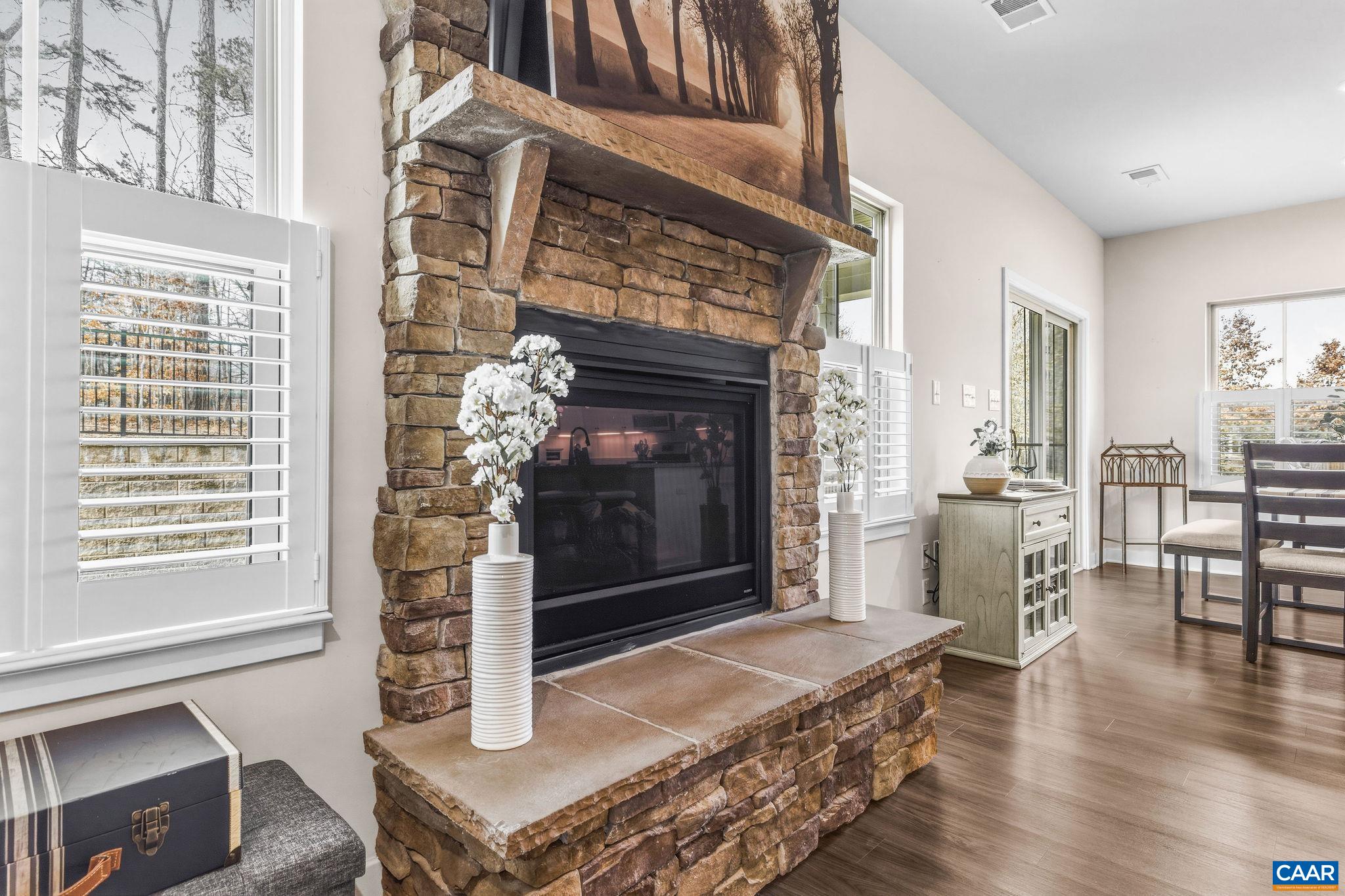360 Winding Road Keswick, VA 22947 - Photo 16 of 48 a living room with furniture a fireplace and wooden floor