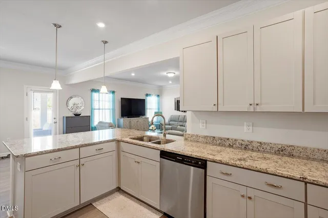 a large kitchen with stainless steel appliances granite countertop a sink dishwasher stove top oven and wooden cabinets