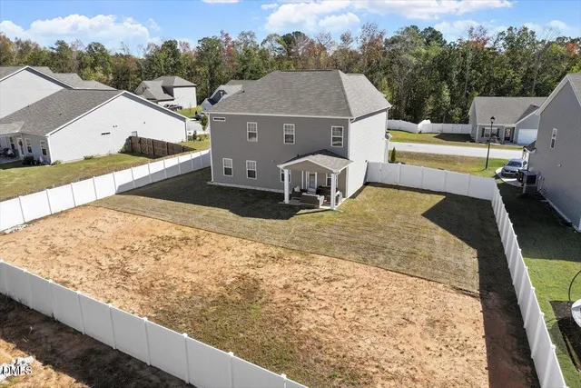 an aerial view of a house with swimming pool and mountain view