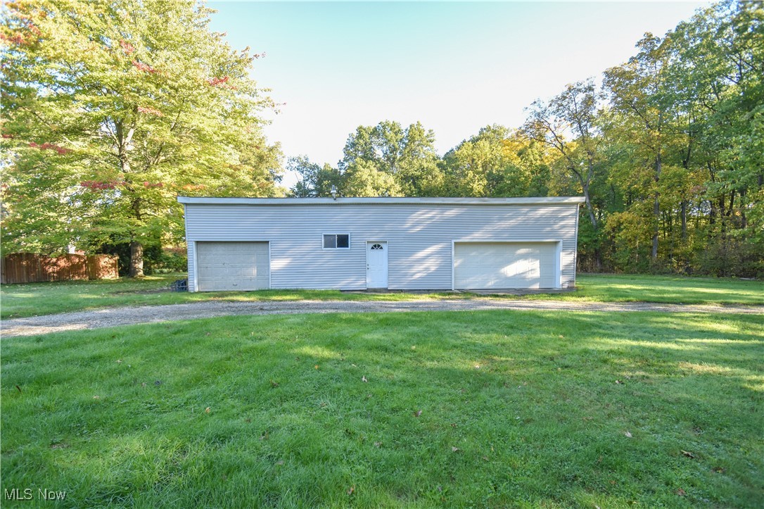 5382 West Webb Road Youngstown, OH 44515 - Photo 25 of 50 View of outbuilding featuring a garage and a lawn