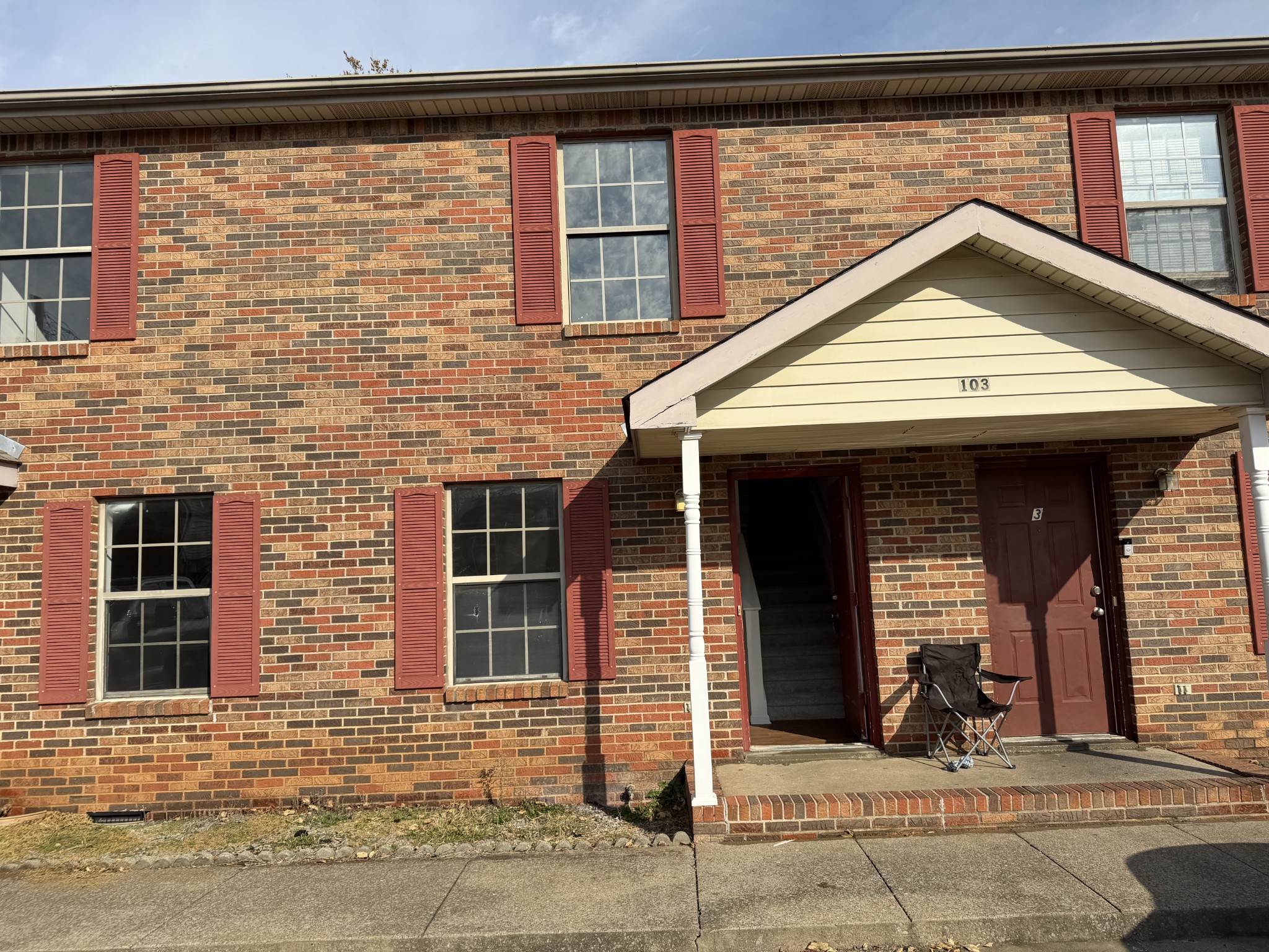 a view of a brick house with large windows
