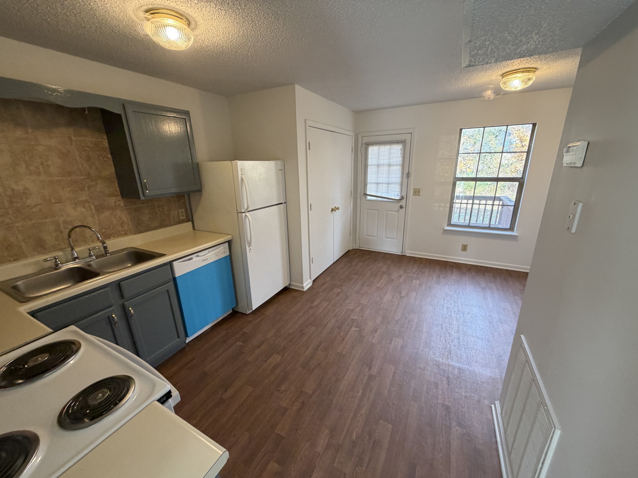 103 Hickory Trace Road, Unit 2 Clarksville, TN 37040 - Photo 3 of 7 a view of a kitchen with wooden floor and electronic appliances