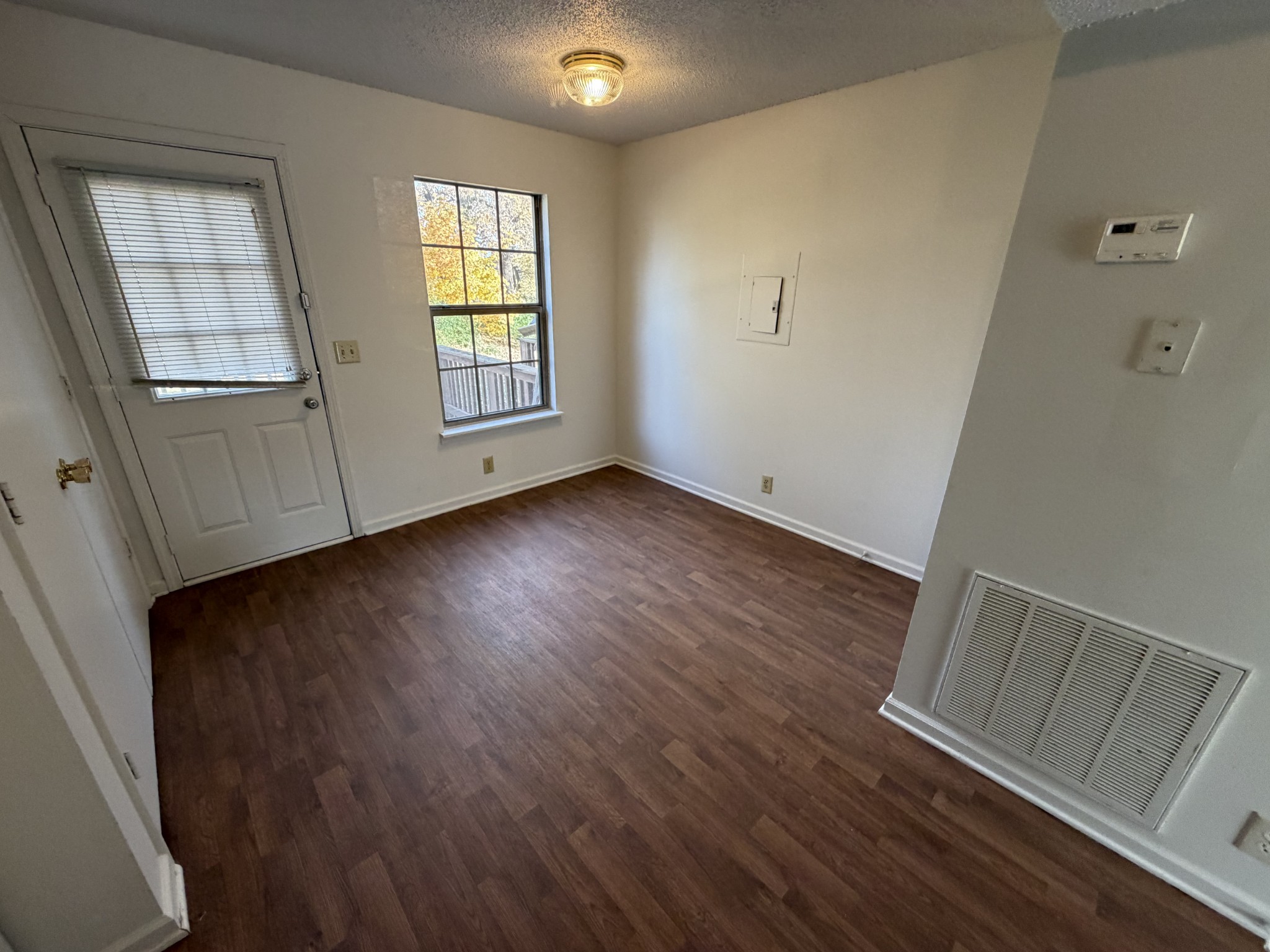 103 Hickory Trace Road, Unit 2 Clarksville, TN 37040 - Photo 5 of 7 a view of an empty room with wooden floor and a window